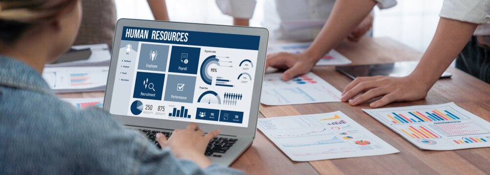 Human resources management software on computer screen helping human resources employee to manage recruitment, payroll, staff searching and KPI evaluation brisk
