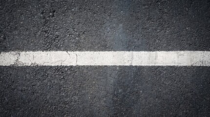 Fototapeta premium Top view of textured black asphalt road with a distressed white line marking