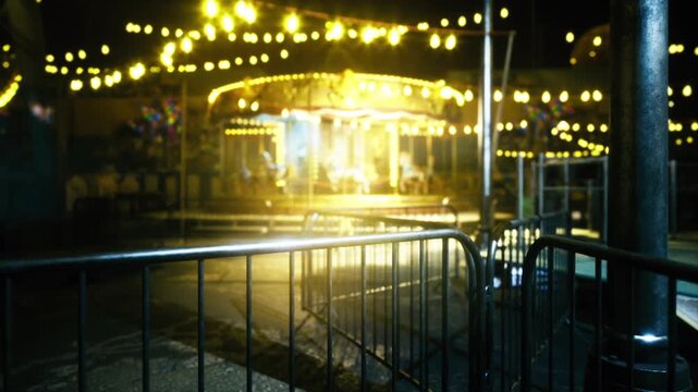 Blurred carousel lights create dreamy bokeh, shallow depth and wet reflections, soft focus ride glowing in warm tones, cinematic evening hush