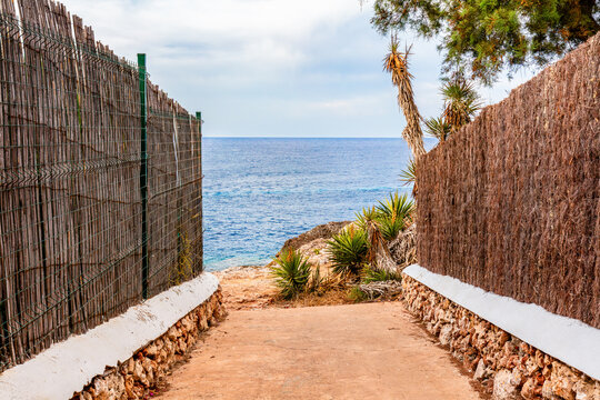 Coastal pathway to sea in scenic Cala d'Or, Mallorca, Spain.