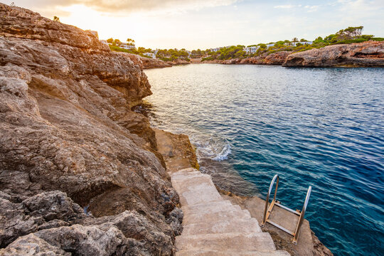 Stone stairway descending to cove in Cala d'Or, Mallorca, Spain.