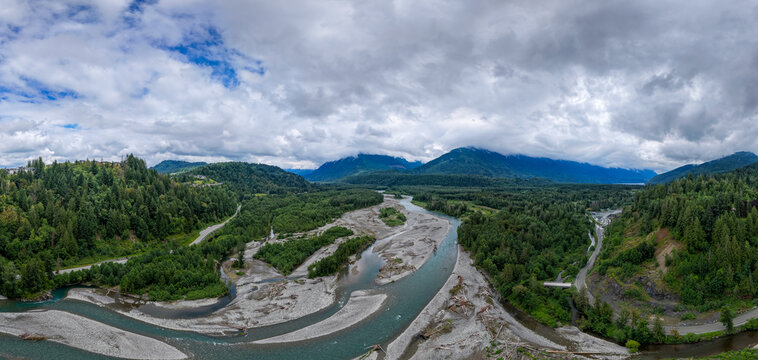 Braided River and Lush Evergreen Valley Below Cloudy Mountains in Fraser Valley, Chilliwack, British Columbia