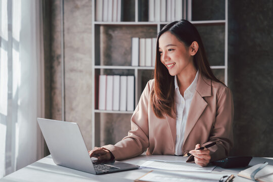 Asian Woman Working on Laptop at Desk in Home Office Smiling | Remote Work Career Business Professional Finance Consultant Analyst Accounting