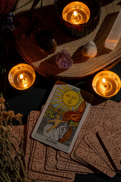 tarot card reading with candles and crystals creating mystical and spiritual ambiance