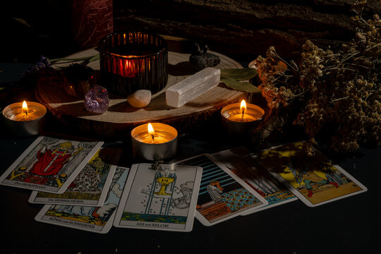 tarot cards and candles on mystical altar for spiritual meditation and fortune telling