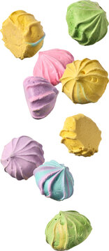 pastel meringue kisses falling isolated white background, colorful sweet baked dessert cookies with swirl shape in close-up view