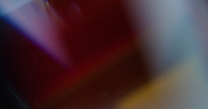 Neon color gleam. Blur rainbow art. Yellow purple blue glisten texture optical light vivid glass leak on abstract vibrant background.