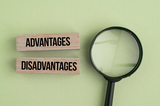 A magnifying glass with the words Advantages and Disadvantages. The concept of advantage or disadvantage of something.
