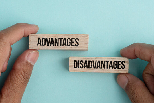 Hand holding a stick with the words Advantages and Disadvantages. The concept of advantage or disadvantage of something.
