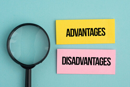A magnifying glass with the words Advantages and Disadvantages. The concept of advantage or disadvantage of something.