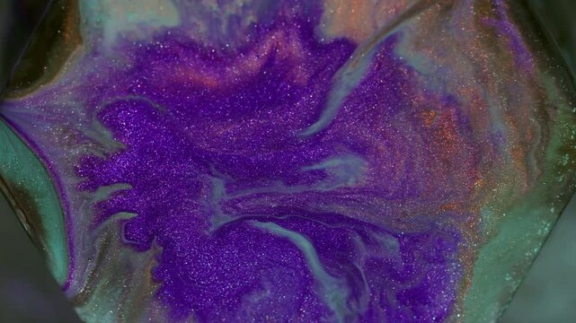 Spatter ink. Paint rhombus. Defocused purple blue orange color glitter stone geometric water sparkling fluid floating on abstract background.