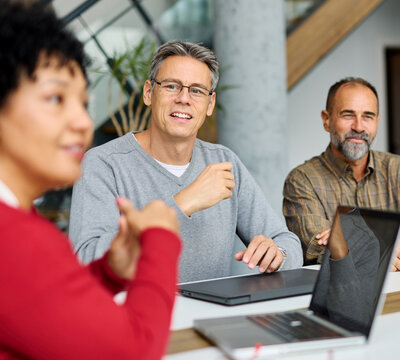 Businesspeople having a meeting in the office. Teamwork and success concept, portrait of a smart mid aged  businessman, two businesspeople talking planning brainstorming