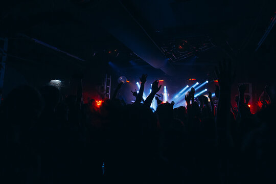 Audience hands waving during a live music concert
