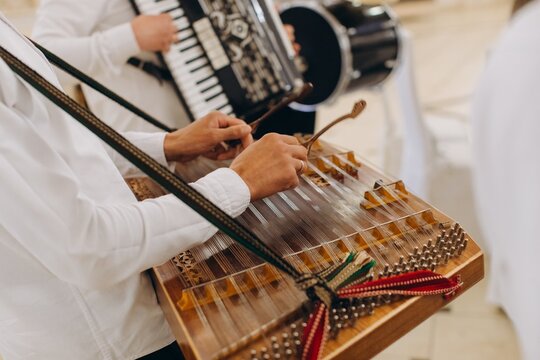 Musician playing string instrument with mallets during concert