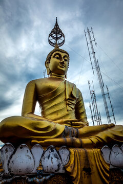 Giant golden Buddha statue at the top of Wat Tham Suea temple in Krabi, Thailand