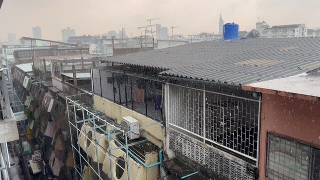 BANGKOK, THAILAND - APRIL 2026 : View of heavy squall raining down on the city street. Concept of tropical climate weather, torrential storm and sudden monsoon downpour.