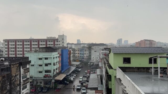 BANGKOK, THAILAND - APRIL 2026 : View of heavy squall raining down on the city street. Concept of tropical climate weather, torrential storm and sudden monsoon downpour.