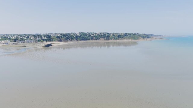 Aerial view of a wide aerial view of the sandy beach and coastal town of Binic in Brittany, France.
