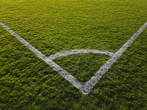 a soccer ball on the green grass on the line on corner in soccer stadium. corner kick.