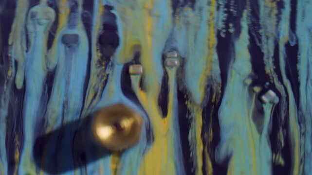 Processor detail. Paint stream. Blue yellow liquid spill on technological texture. Modern color abstract blur circuit art background.