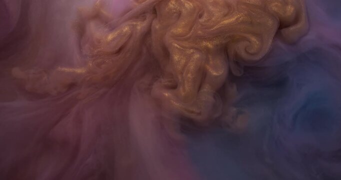 Sparkling smoke ink. Pigment blend. Golden metallic fume paint swirl in colorful liquid. Glitter defocused curl stream texture abstract background.