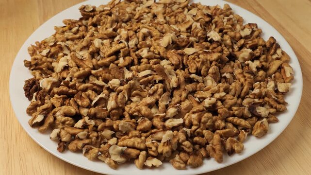 Rotating plate of shelled walnut kernels