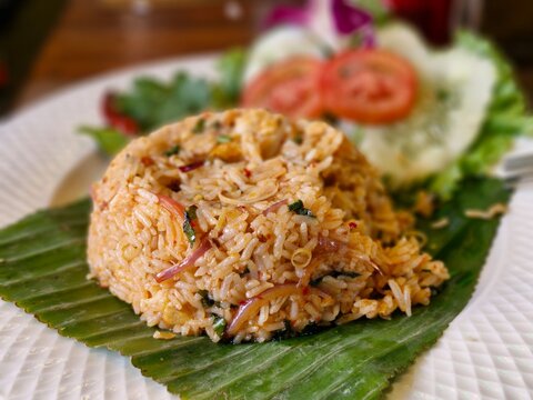 Khao Pad Tom Yum served with fresh vegetables in Thailand during a sunny afternoon