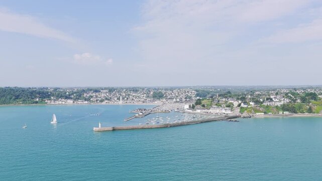 A high-angle aerial shot captures the picturesque coastal town and port of Binic in Brittany, France.