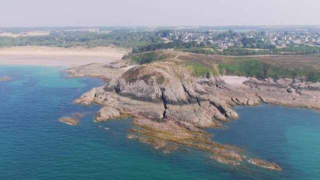 Aerial view of the rocky headland and turquoise waters of Anse du Croc near Frehel, Brittany, France.