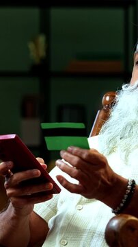 Indian mid age bearded man expressing distress because of online fraud after debit card payment using smartphone at home, stylish mature male feeling frustrated over digital scam and financial theft