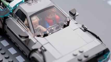 Fototapeta premium Tambov, Russian Federation - July 12, 2026 A close-up of Lego Marty McFly and Doc Brown minifigures sitting inside the DeLorean time machine car behind the windshield. Back to the Future.