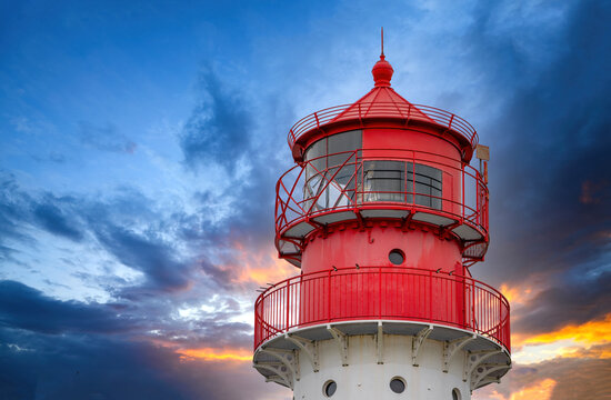 Red Lighthouse Tower at Dramatic Sunset