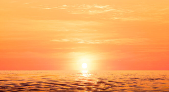 Sea Sunset Background with Natural Sunlight  and Sun on Orange Summer Sky with  Light Reflection on Water surface in Golden Hour time