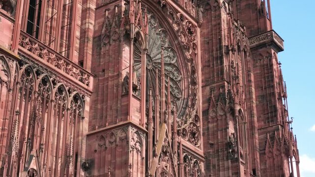 Low angle view revealing the detailed sculptures and rose window of the Notre Dame Cathedral in Strasbourg