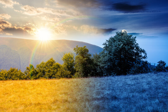 mountain landscape of ukraine. day meet night. sun and moon over alpine grassy meadow and deciduous forest on the hill. equinox nature background for carpathian adventures