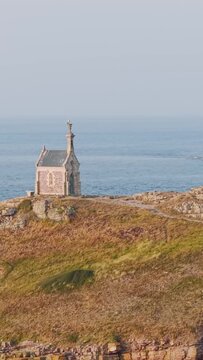 A scenic view of the historic chapel on Ilot Saint Michel, located off the coast of Erquy in Brittany, France.