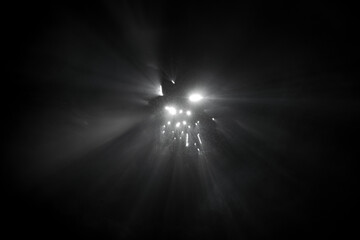 Obraz premium Abstract fog. White light rays, mist or smog moves on black background. Beautiful swirling gray smoke. Mockup for your logo.