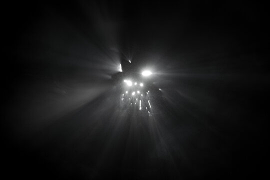 Abstract fog. White light rays, mist or smog moves on black background. Beautiful swirling gray smoke. Mockup for your logo.