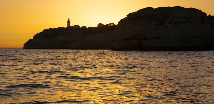 Sailing along the coast of Algarve at sunset, Portugal
