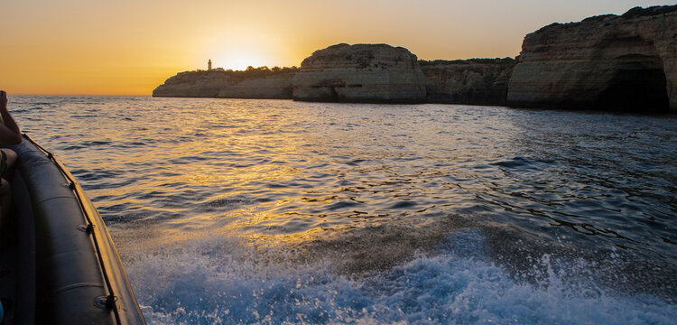 Sailing along the coast of Algarve at sunset, Portugal