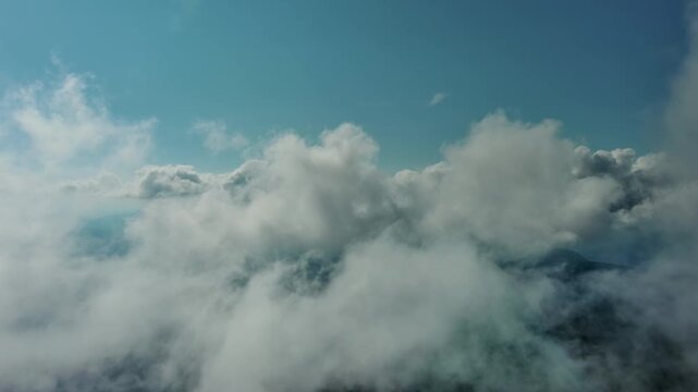 Aerial high view of clouds and blue sky, flying in clouds, 4k