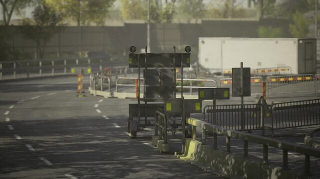 Road construction scene with traffic cones and maintenance truck securing closed lane under overcast light, barriers and guardrail framing composition, textured