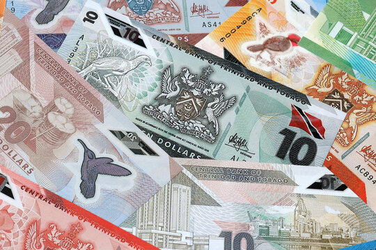 Trinidad and Tobago dollar money bills in pile on table. Trinidad and Tobago TTD currency cash