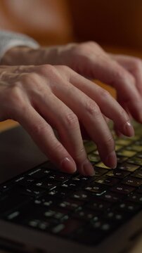 Old hands typing on a laptop keyboard close-up 1080x1920 Social ready