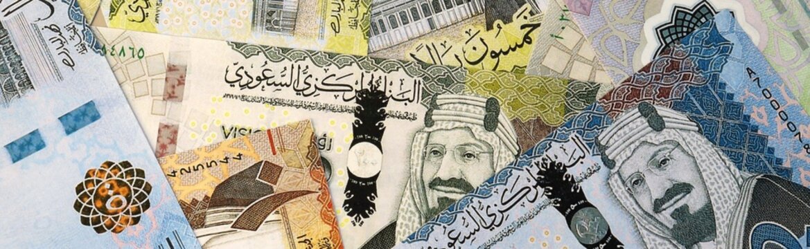 Saudi riyal money bills in pile on table. Saudi Arabia SAR currency cash close up