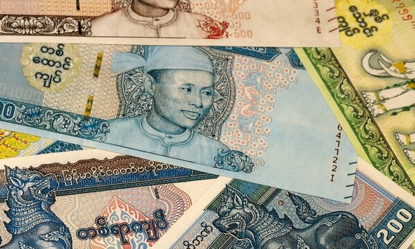 Myanmar kyat money bills in pile on table. Myanmar MMK currency cash close up