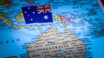 Australian flag pin placed on map of Australia for travel and international business promotion. © Photo Agency