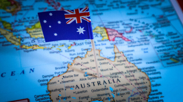 Australian flag pin placed on map of Australia for travel and international business promotion.