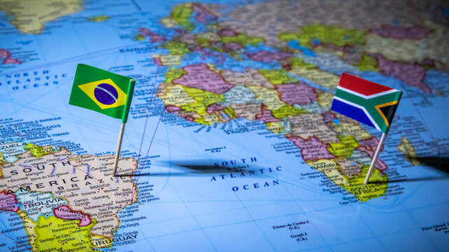 Close up of Brazil and South Africa flags on map showing global connection.