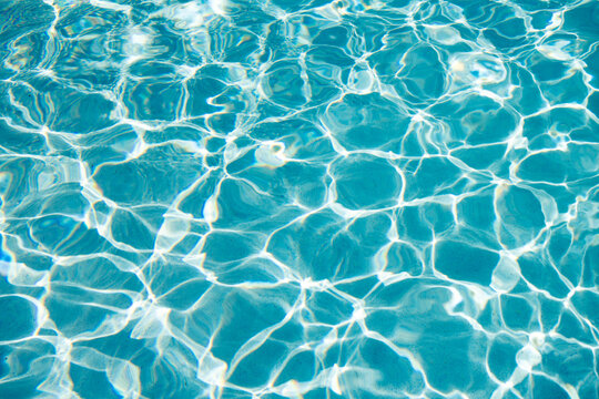 Summer vacation at ocean shore. Blue ocean rippled water texture reflection. Ripple water in summer pool. Sea surface background. Vacation resort water background. Sea beach